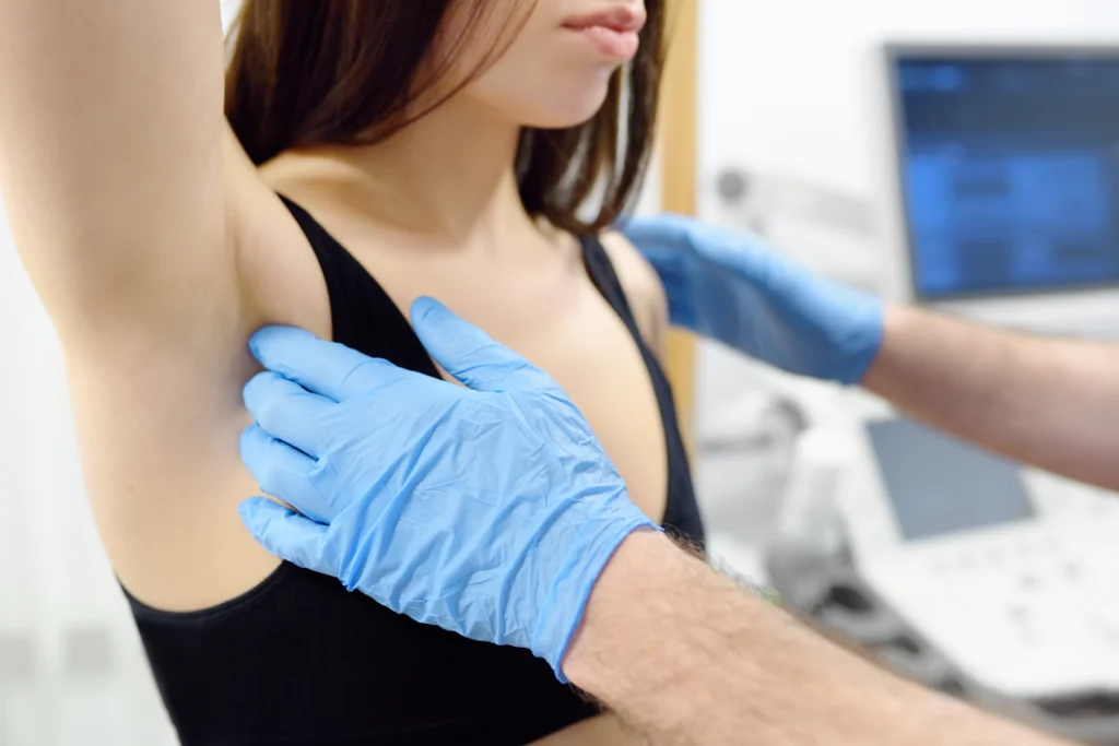 Doctor performing a consultation for a breast lift procedure.